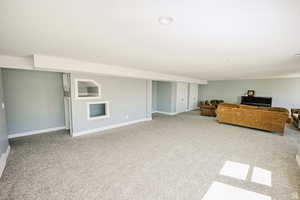 Unfurnished living room with recessed lighting, carpet, and baseboards