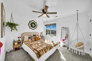 Bedroom featuring a ceiling fan, baseboards, visible vents, and carpet flooring