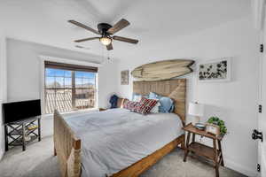 Bedroom with light carpet, baseboards, visible vents, and a ceiling fan