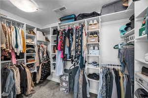 Spacious closet featuring visible vents and carpet flooring