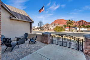 View of patio / terrace featuring a fire pit, a gate, a mountain view, and fence