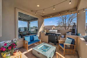 View of patio / terrace featuring an outdoor living space with a fire pit and area for grilling