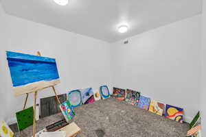 Recreation room with carpet floors and visible vents