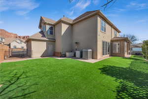 Rear view of house featuring cooling unit, fence, a patio, and stucco siding