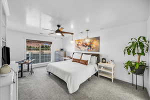 Carpeted bedroom with ceiling fan