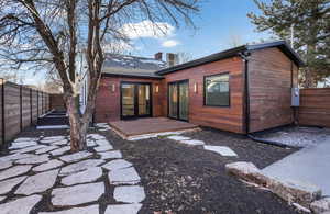 Back of house featuring a patio area, a fenced backyard, and a chimney