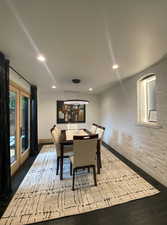 Dining room with french doors, wood finished floors, and recessed lighting