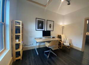 Home office featuring dark wood-type flooring, attic access, track lighting, and baseboards