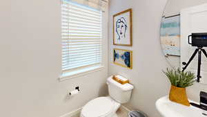 Bathroom featuring toilet and baseboards