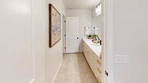 Bathroom with visible vents, vanity, and baseboards