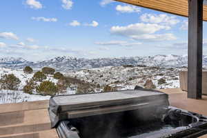 Exterior space with a mountain view and a hot tub