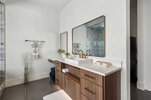 Bathroom featuring vanity, baseboards, and tile patterned floors