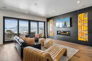 Interior space with recessed lighting, a glass covered fireplace, and light wood-style floors