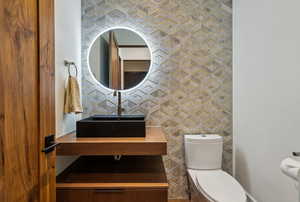 Half bath with a sink and toilet