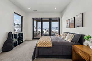 Bedroom featuring access to outside, visible vents, a mountain view, and multiple windows