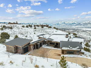 Snowy aerial view featuring a mountain view