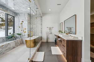 Full bath featuring a freestanding tub, recessed lighting, vanity, visible vents, and a marble finish shower