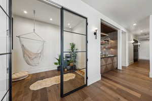 Corridor with baseboards, dark wood-type flooring, and recessed lighting