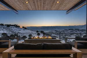 Exterior space featuring an outdoor living space with a fire pit and a mountain view