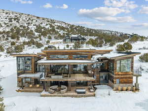 Snow covered house featuring a mountain view