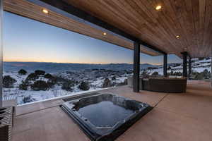 Snow covered patio featuring an outdoor hangout area and a mountain view