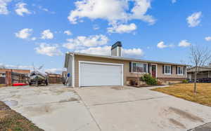 Ranch-style home with driveway, an attached garage, fence, a front yard, and brick siding. Room for RV