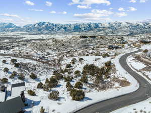 Snowy aerial view featuring a mountain view