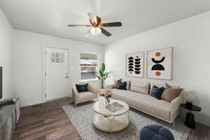 Living area with ceiling fan, dark wood floors (Virtually Staged)