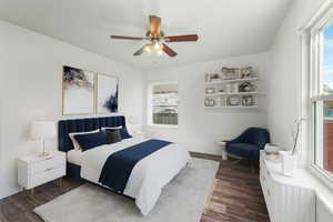 Bedroom with a ceiling fan and dark wood-style flooring (Virtually Staged)