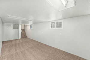 Basement with carpet flooring and stairway