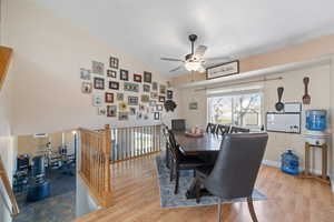 Dining room with ceiling fan, baseboards, and wood finished floors