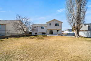 Back of house featuring a patio, a yard, and a fenced backyard