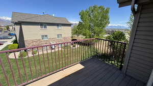 Wooden deck with a mountain view and a lawn