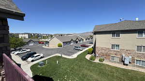 Exterior space with a residential view, uncovered parking, and a yard