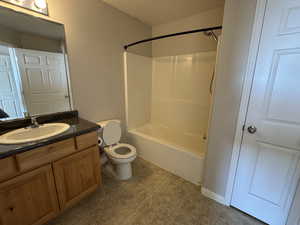 Full bathroom featuring toilet, tile patterned floors, bathing tub / shower combination, and vanity