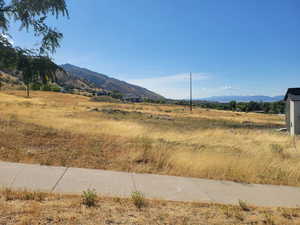 View of mountain backdrop featuring rural landscape