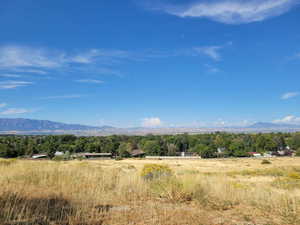 View of mountain backdrop featuring rural landscape