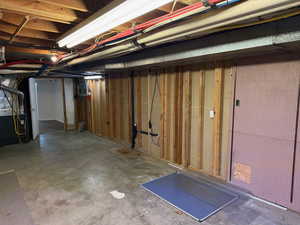 Unfinished basement featuring heating unit