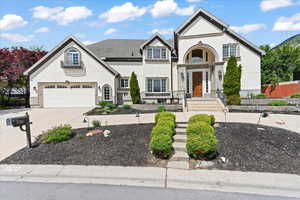 View of front of home with driveway, an attached garage, and stucco siding