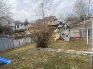 View of yard featuring fence