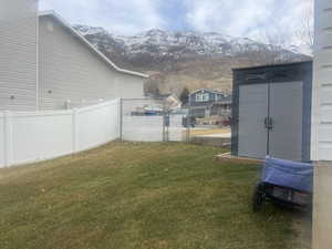 View of yard with fence and a mountain view