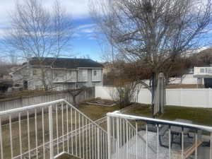 Exterior space featuring a front yard and a fenced backyard