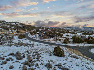 Snowy aerial view featuring a residential view and a mountain view