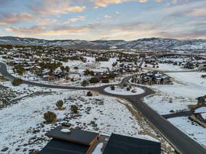 Snowy aerial view featuring a residential view and a mountain view