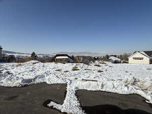 Snowy yard featuring a mountain view