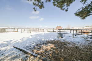 Yard covered in snow with fence