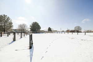 Snowy yard featuring fence