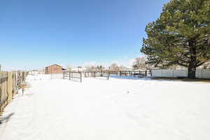 Snowy yard featuring fence