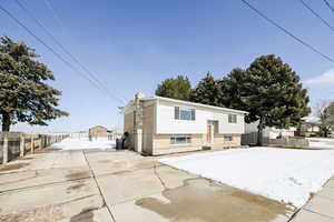 View of front of home with fence and brick siding