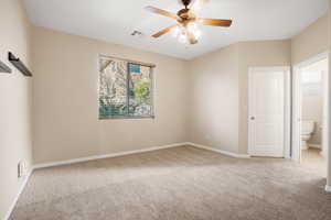 Spare room with light carpet, ceiling fan, visible vents, and baseboards